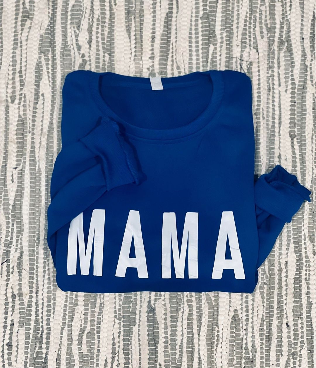 Mama Blue with white block lettering